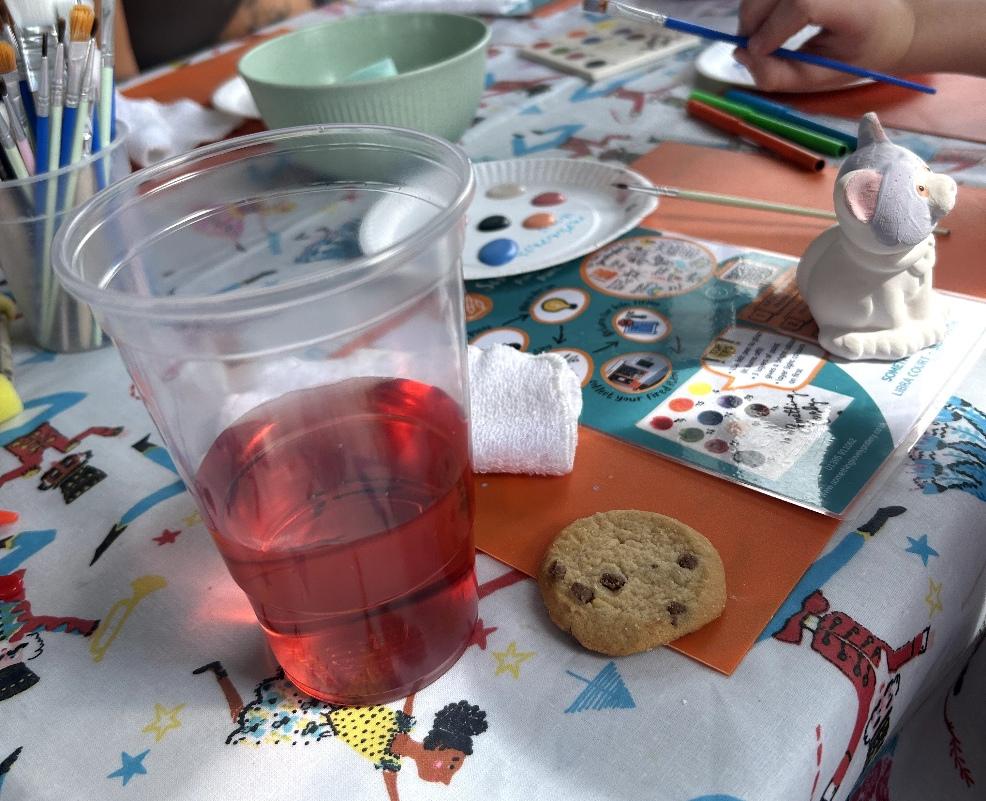 picture of a glass of squash and biscuit at Something Lovely pottery painting session