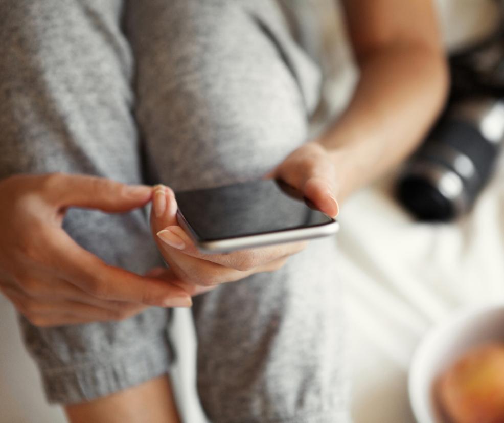 picture of a Teen looking at a smart phone