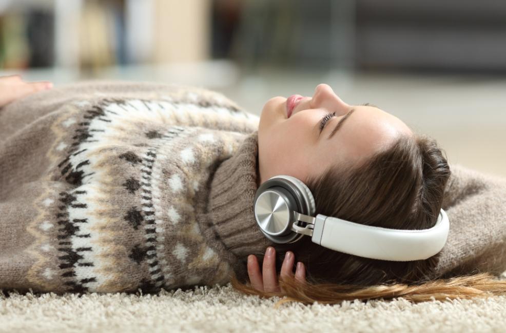 picture of a Teenager laying on the floor wearing headphones