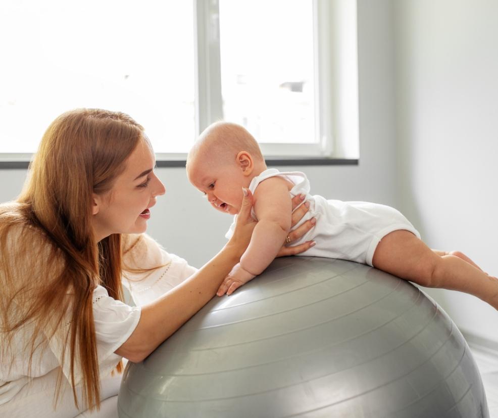 picture of a baby having tummy time on a blow up exercise ball