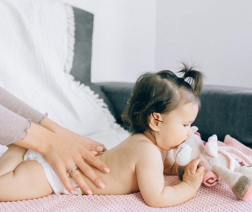 picture of a baby laying on her tummy having a massage
