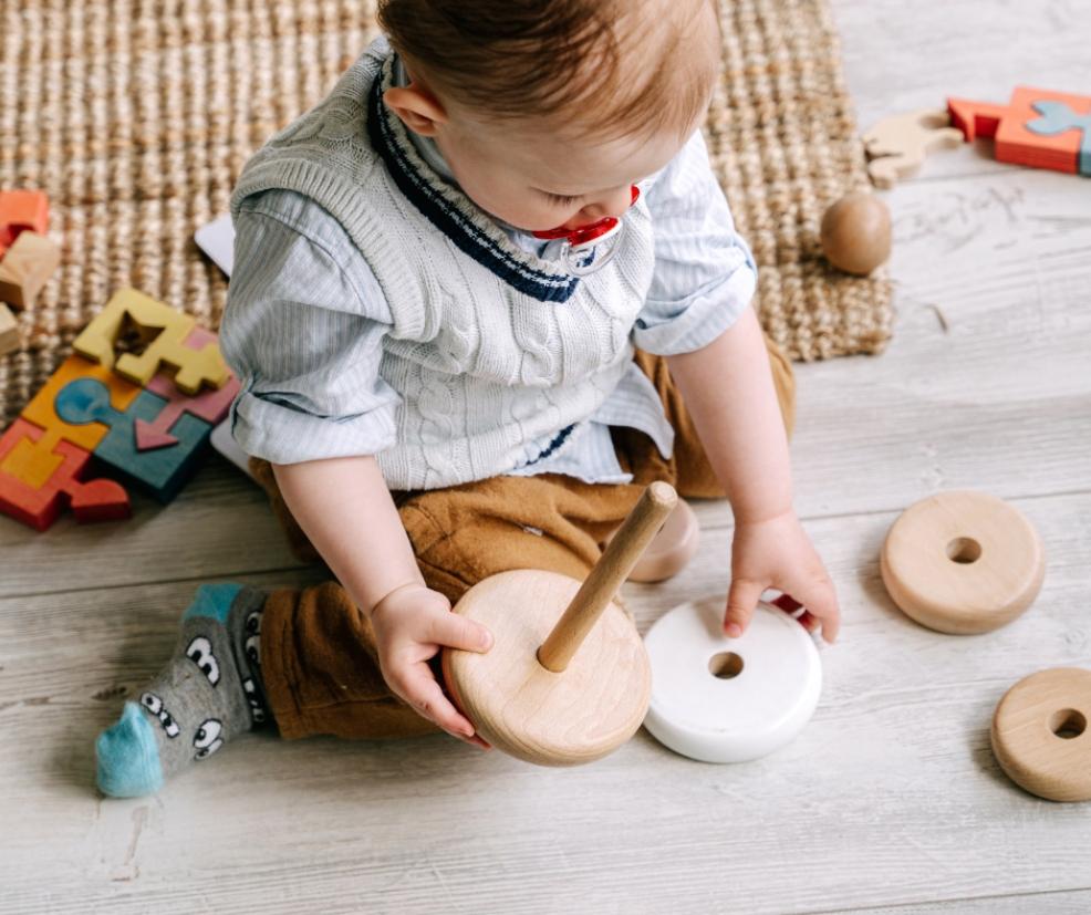picture of a baby playing with natural wooden toys