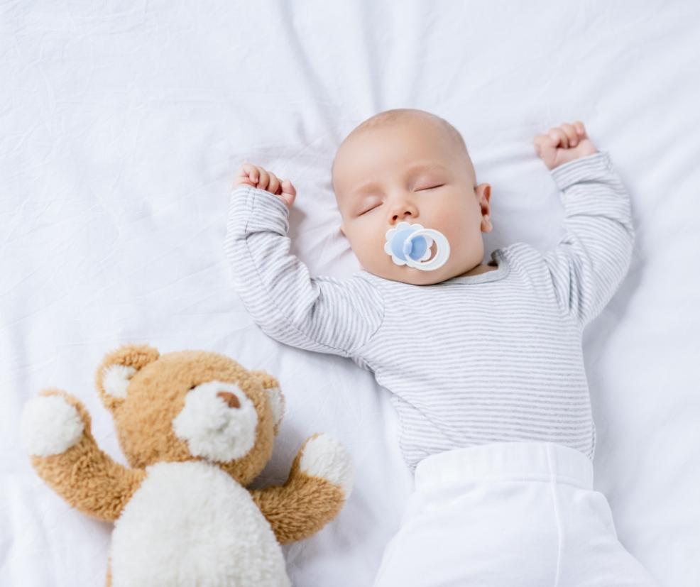 picture of a baby sleeping with a dummy