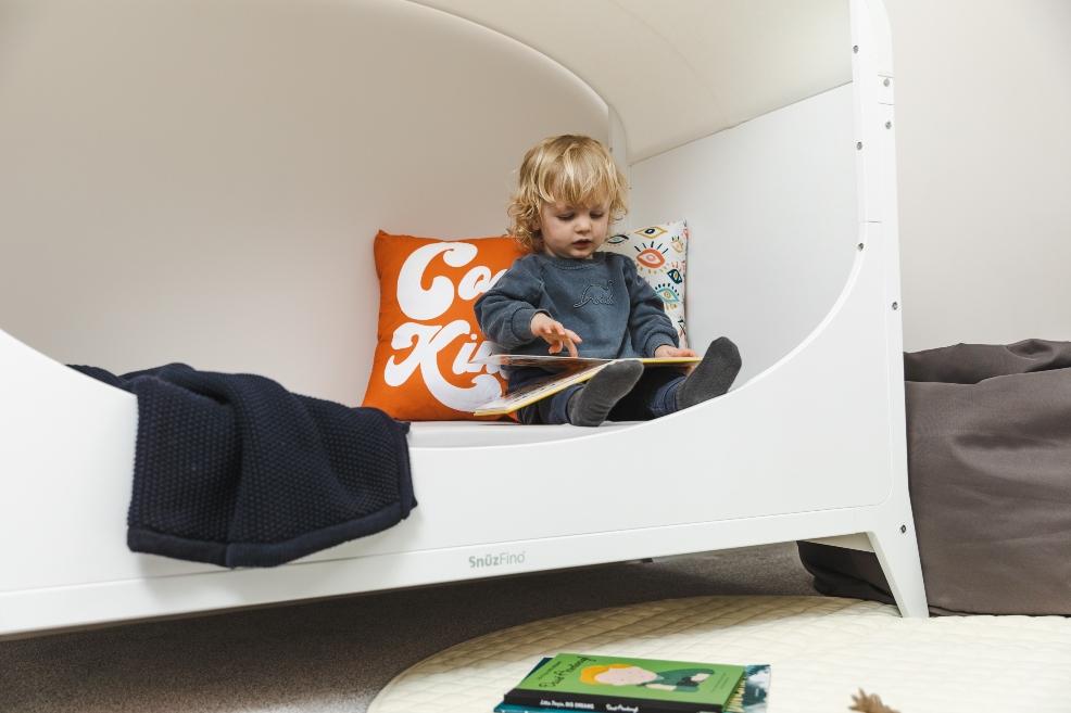 picture of a child in SnüzFino Cot bed