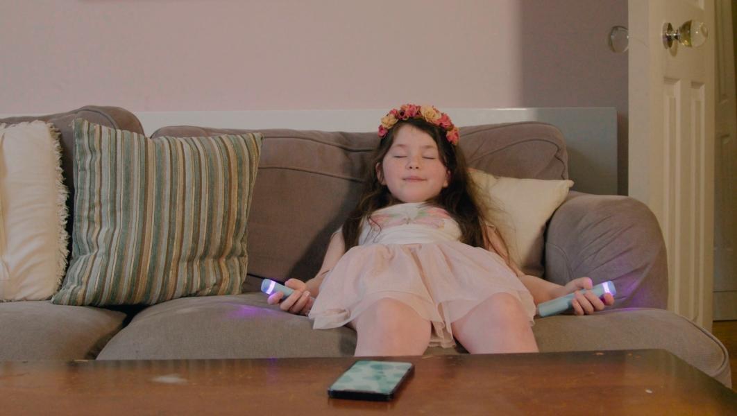 picture of a child relaxing with Stix Mindfulness Remotes