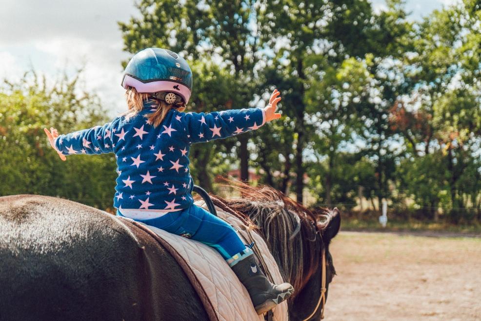 picture of a child riding a horse