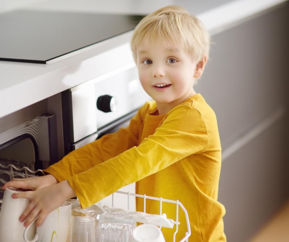 picture of a child using the dishwasher