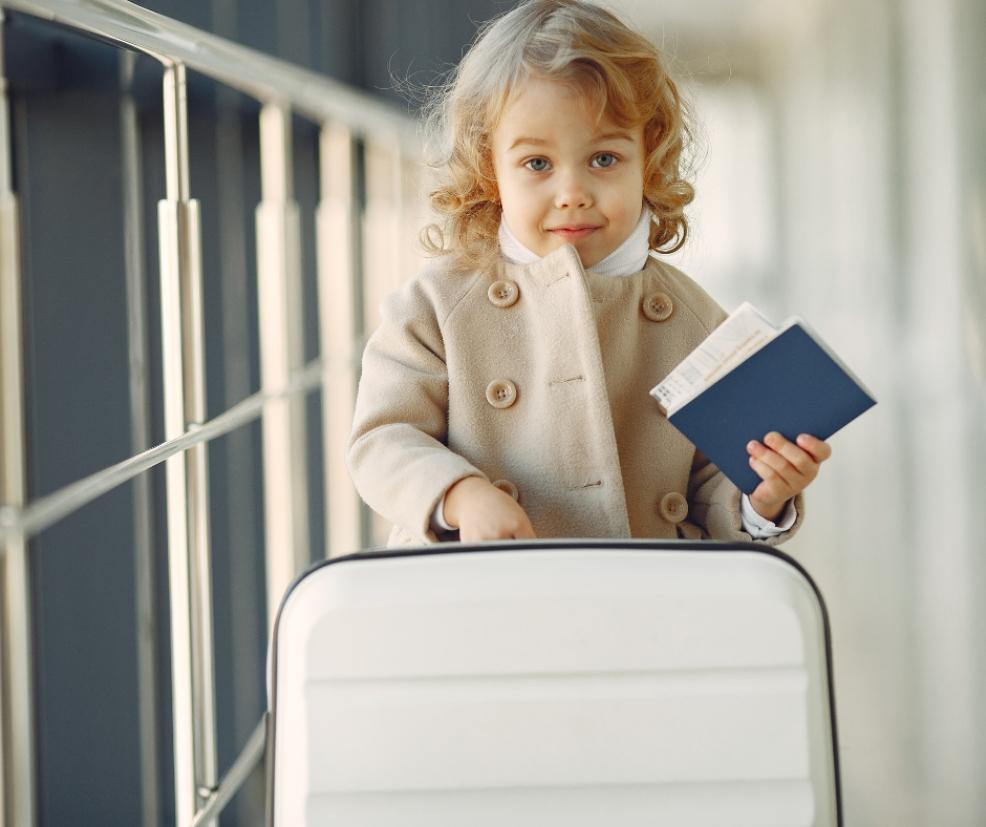 picture of a child with suitcase and passport