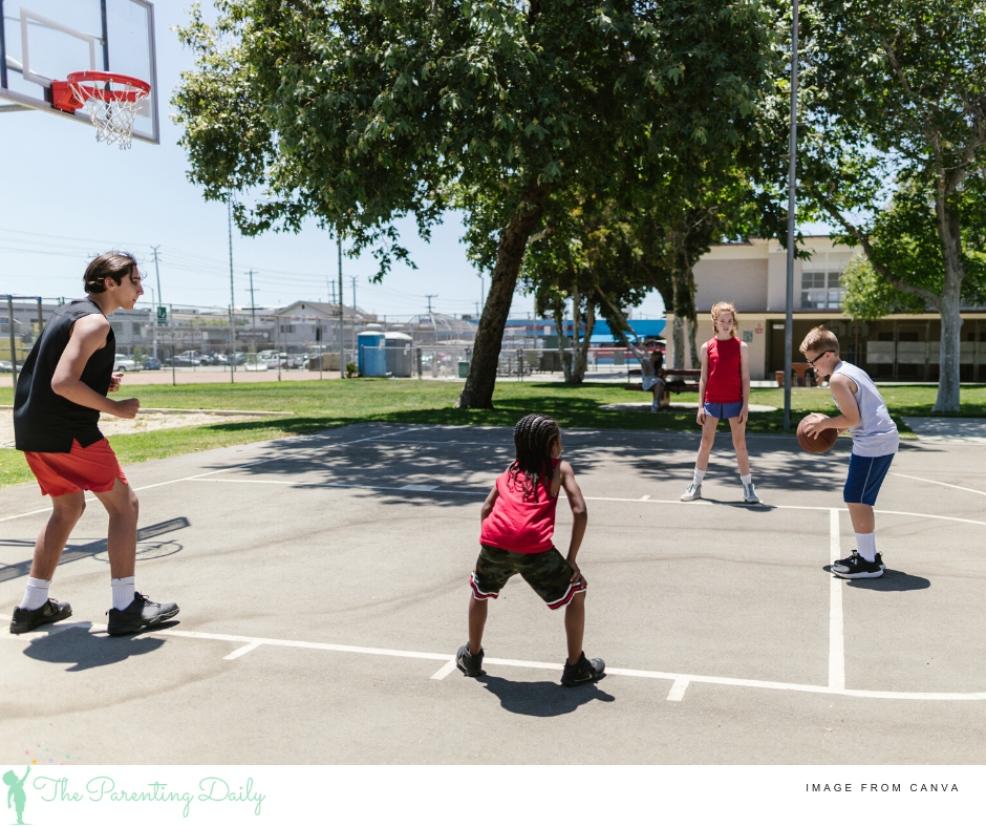 picture of children outdoors playing basketball
