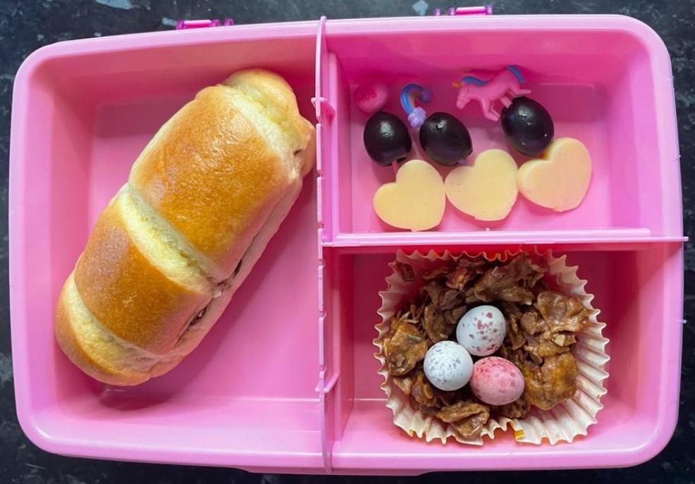 picture of a childrens pink lunchbox with a chocolate brioche