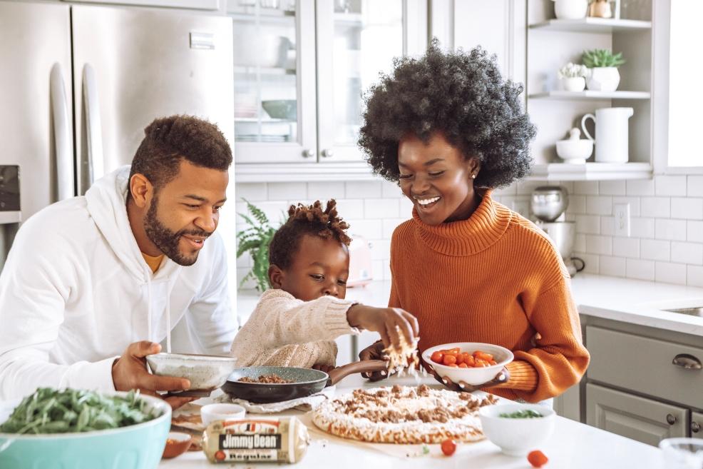 picture of a family making pizza