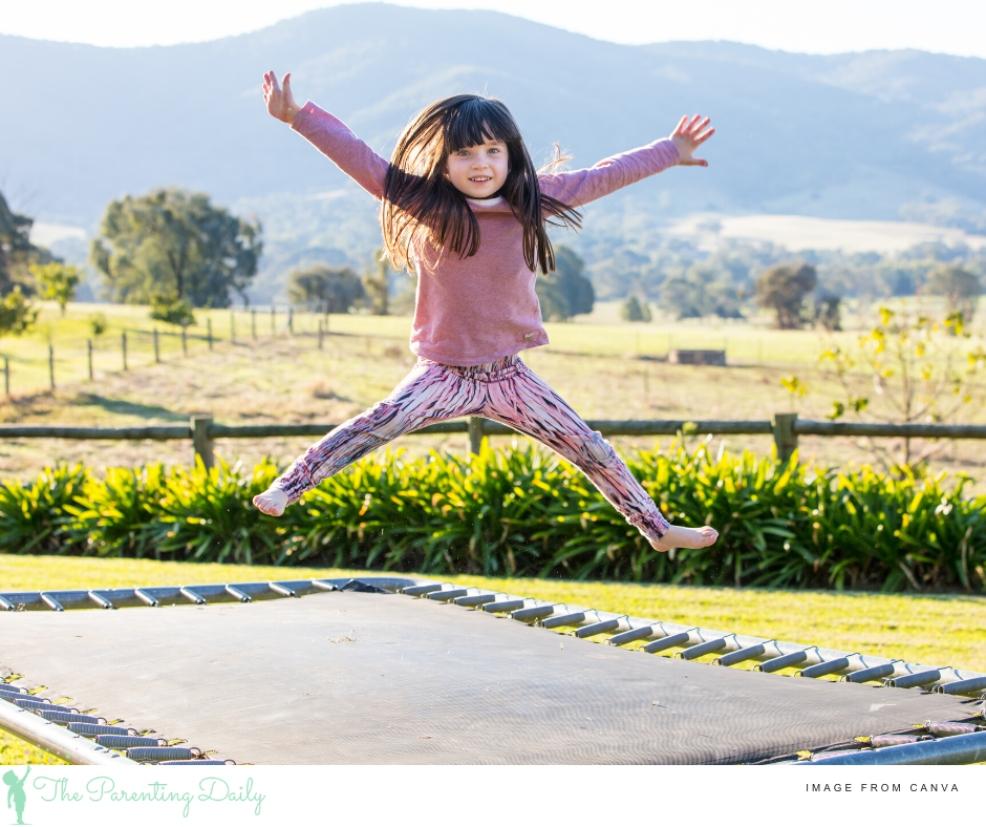 happy child outside on a trampoline picture of a happy child outside on a trampoline