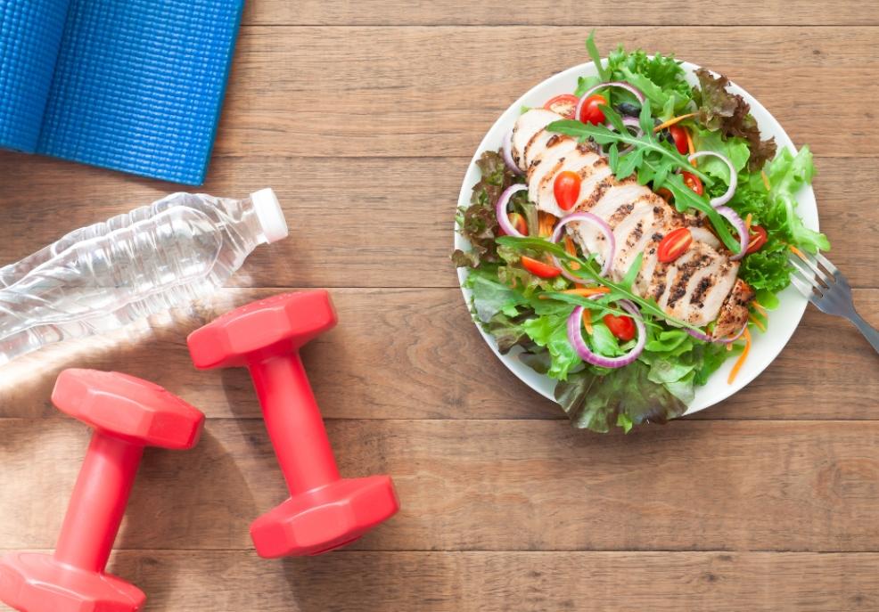 picture of healthy food and exercise equipment