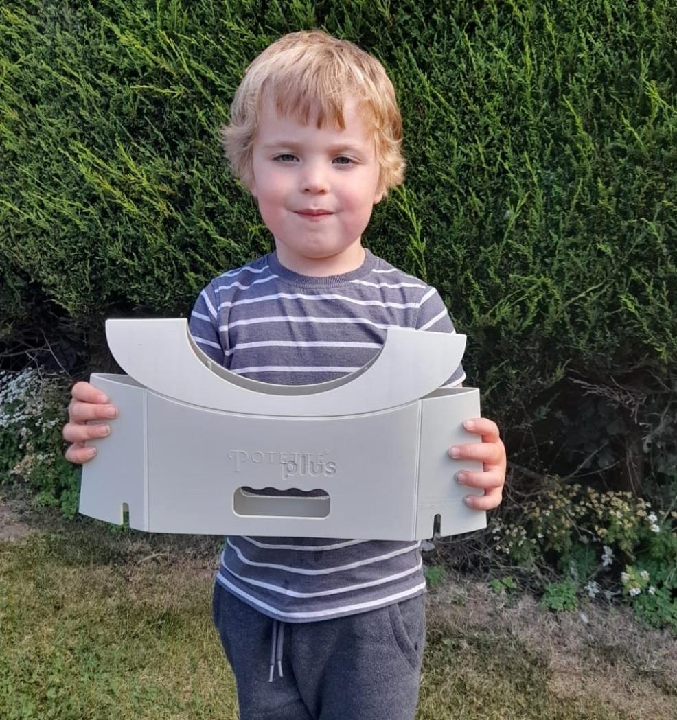 picture of a child holding up a potette plus ready to use outside on the go
