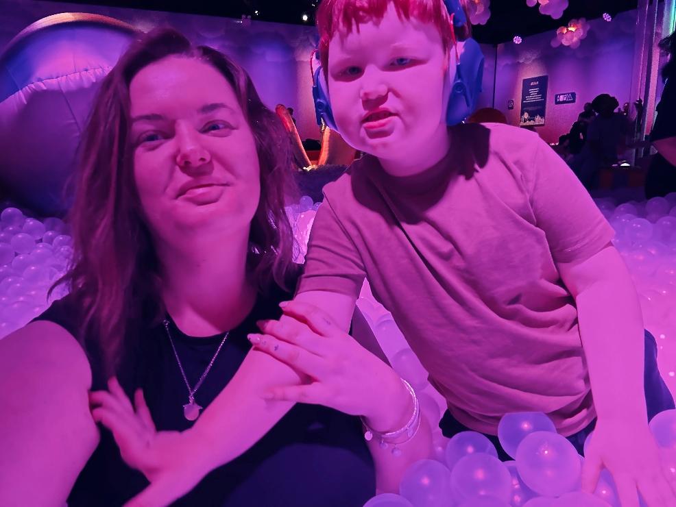 picture of a mum with her autistic child in a ball pool