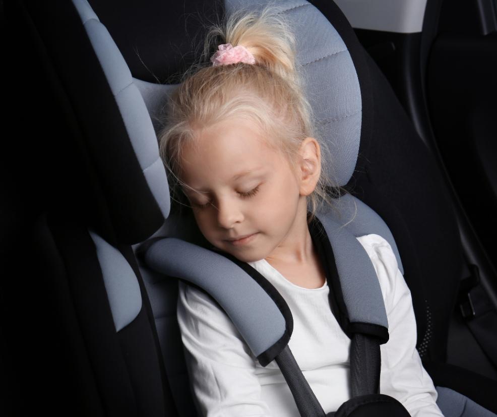 picture of a toddler asleep in the carseat