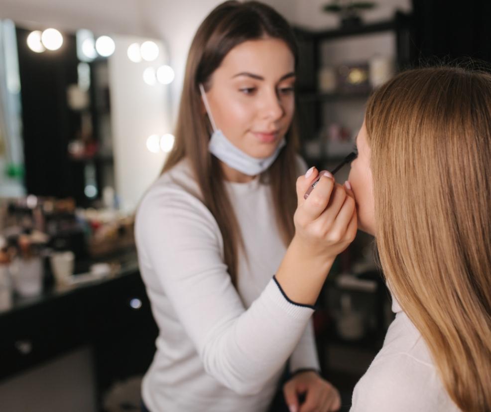 picture of a woman having her make up done