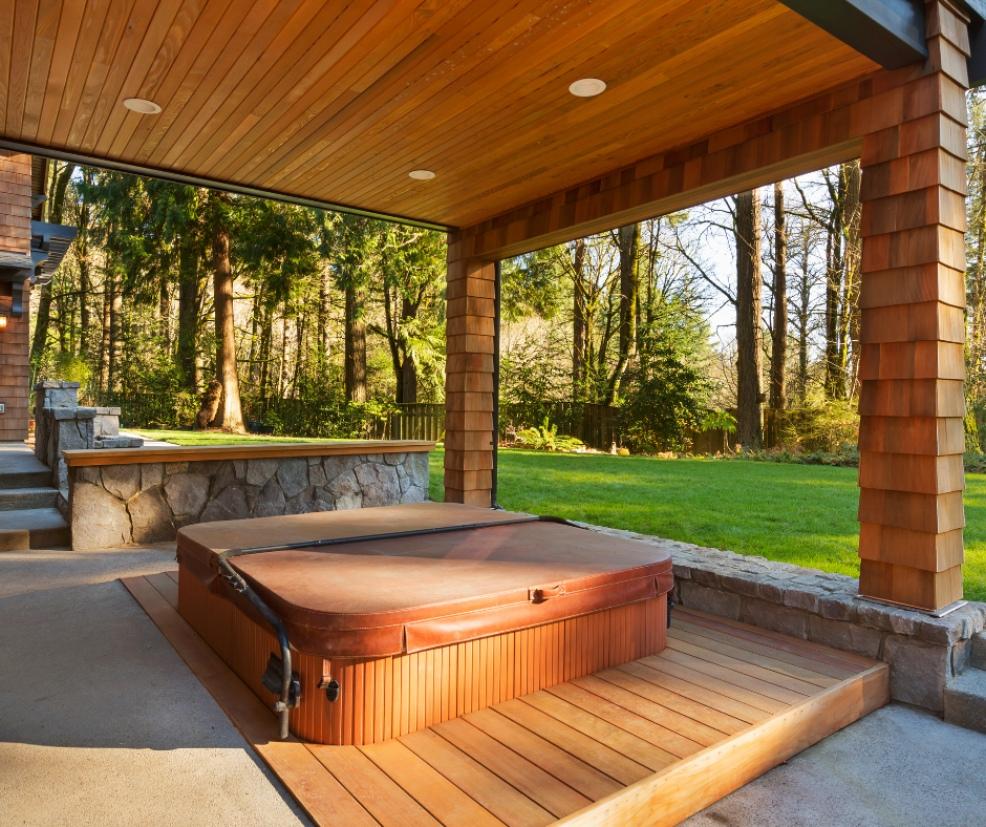 picture of hot tub on decking under a shelter