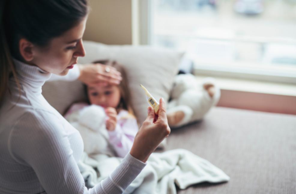 picture of mum taking poorly childs temperature