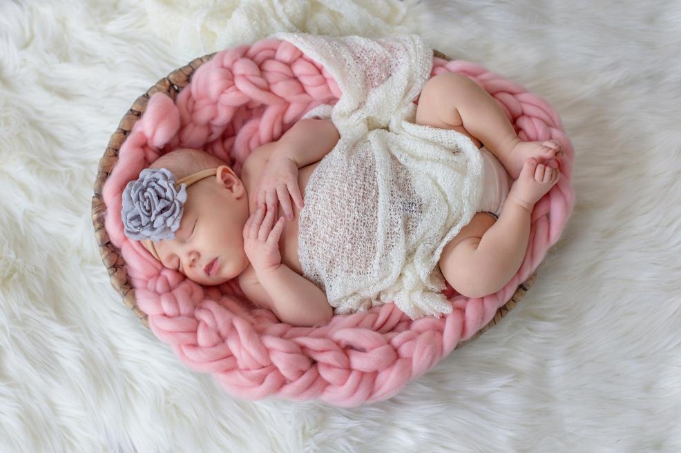 picture of a newborn baby on a pink blanket for a newborn photoshoot