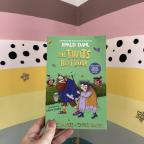 picture of The Twits Next door childrens book in front of a rainbow wall