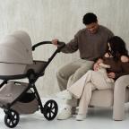 picture of a family with their newborn baby and their Tutis mio 3 stroller in soft beige