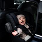 a happy baby in a Axkid Minikid rear facing car seat picture of a happy baby in a Axkid Minikid rear facing car seat