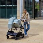 picture of a mum using a Ickle Bubba Altair Double Pram in a city centre out shopping