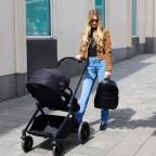 a mum using the Altima Black 9 piece pushchair set picture of a mum using the Altima Black 9 piece pushchair set