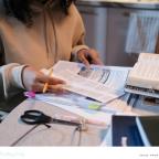 a child revising at home for exams in a calm way with resources on the table picture of a child revising at home for exams in a calm way with resources on the table