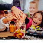 picture of a happy family digging into a sweet jar at Halloween