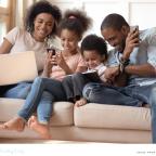 a happy family using their own devices together picture of a happy family using their own devices together