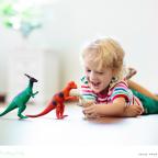 a happy toddler playing with dinosaurs and practising animal sounds picture of a happy toddler playing with dinosaurs and practising animal sounds