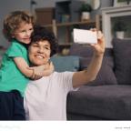 a mum taking a selfie photograph of her and her son on her smartphone picture of a mum taking a selfie photograph of her and her son on her smartphone