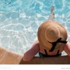 a woman sitting in a pool on holiday whilst solo travelling picture of a woman sitting in a pool on holiday whilst solo travelling