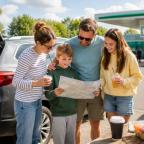 a happy family planning a road trip at a UK service station picture of a happy family planning a road trip at a UK service station