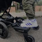 a child standing on a Lascal buggy board attached to a pram picture of a child standing on a Lascal buggy board attached to a pram
