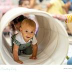 picture of a baby going through a play tunnel at nursery