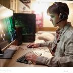 picture of a boy online gaming on a desktop computer in his bedroom