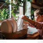 a child learning independence through household chores like doing the dishes picture of a child learning independence through household chores like doing the dishes