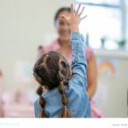picture of a child putting her hand to to ask a question