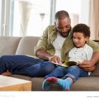 a father and son building a love of reading by reading a book together picture of a father and son building a love of reading by reading a book together