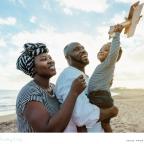 picture of a happy African family on a beach