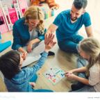 a happy family enjoying plating a board game together at home picture of a happy family enjoying plating a board game together at home