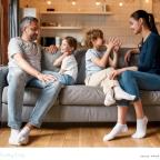 a happy family sat on a sofa talking to eachother building good communication skills picture of a happy family sat on a sofa talking to eachother building good communication skills