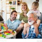 a happy three generational family members getting ready to talk about family finances people of a happy three generational family members getting ready to talk about family finances