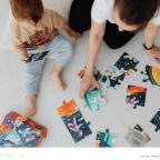 picture of a parent and child doing a puzzle to promote problem solving skills