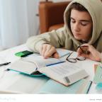 picture of a teenager revising for exams