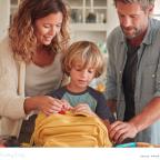 picture of parents helping their child pack their school bag as part of a evening routine