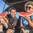 picture of children eating watermelon in a car